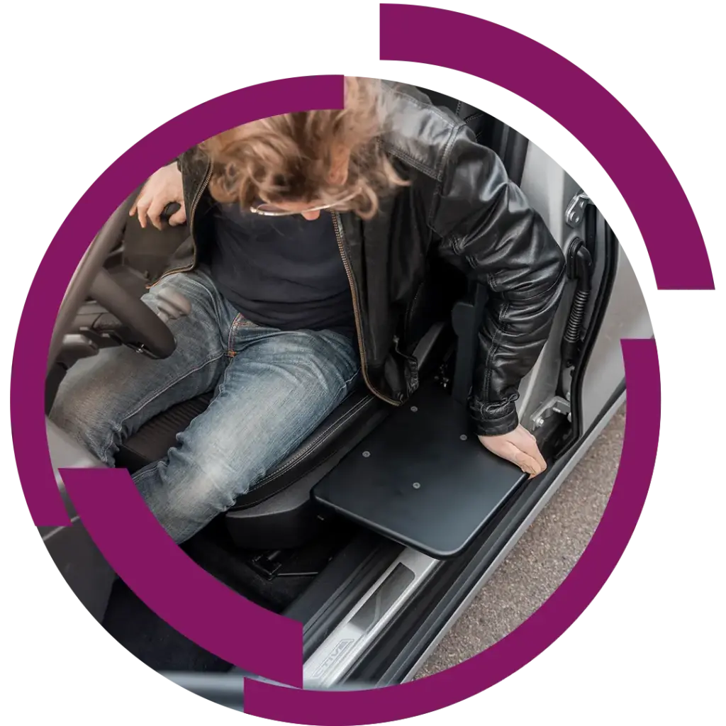 Mann in Lederjacke steigt aus Auto und stützt sich auf eine ausklappbare Trittplatte an der Türschwelle.